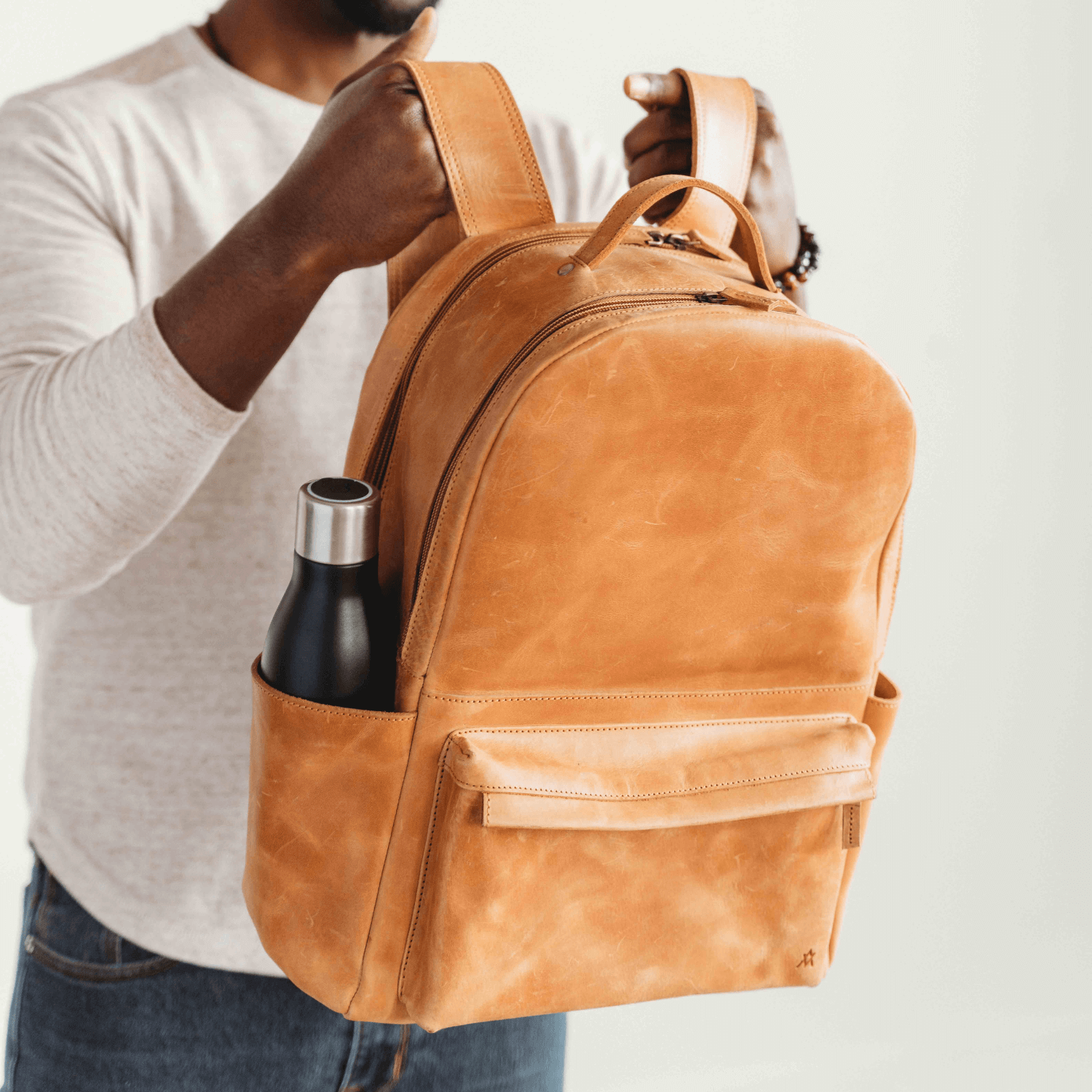 Man holding an Elevate Commuter Backpack