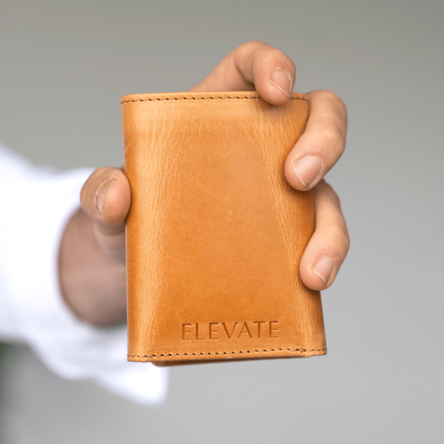 Man holding an Elevate wallet