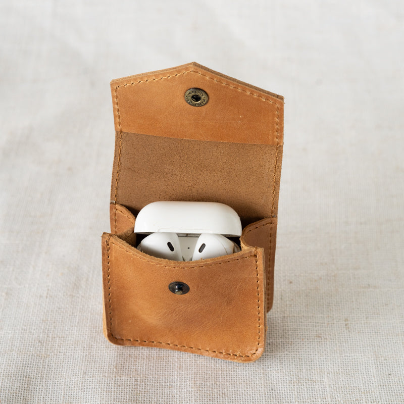 Close up of Airpods in leather Airpod case