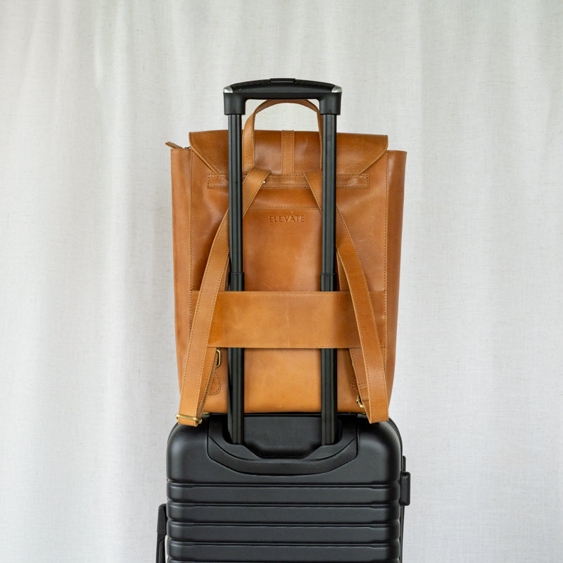 Atlas leather backpack sitting on luggage