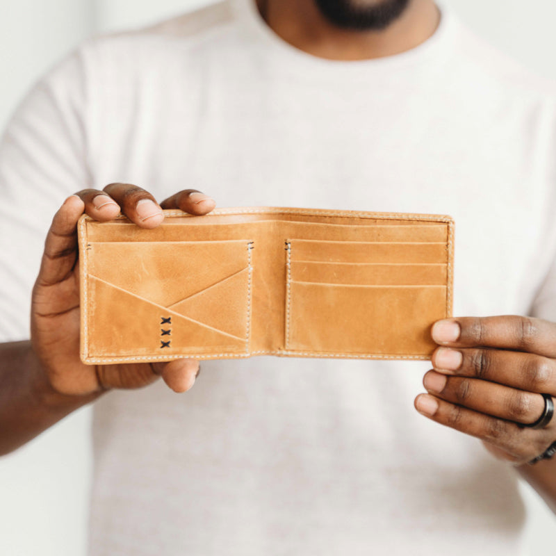 Man holding Elevate bifold wallet 