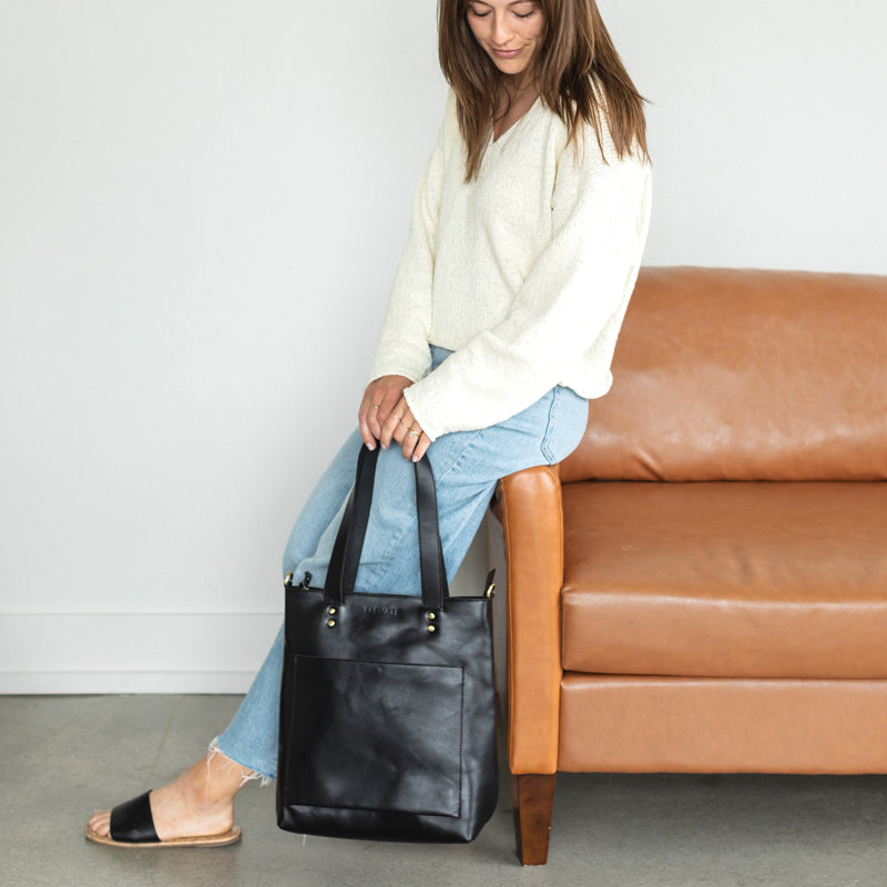 Woman holding Elevate bucket tote 