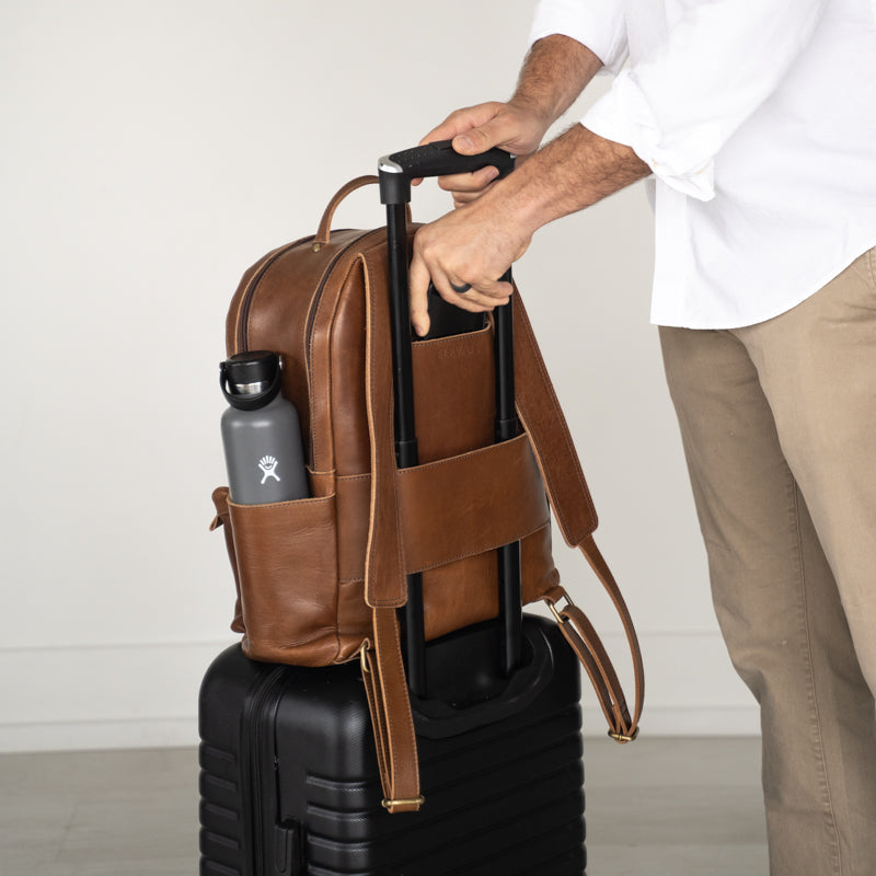 Man with Elevate Commuter Backpack on luggage