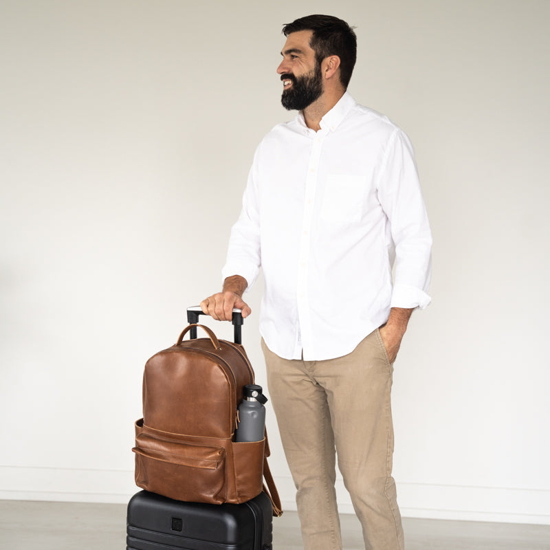 Man with Elevate Commuter Backpack on luggage