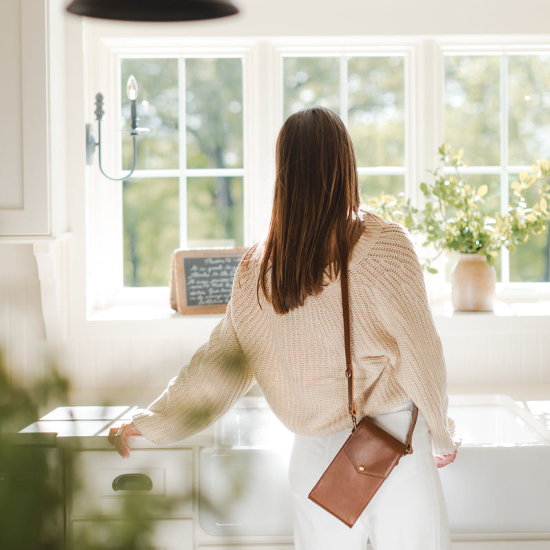 Woman wearing Euro Phone Crossbody by Elevate in kitchen