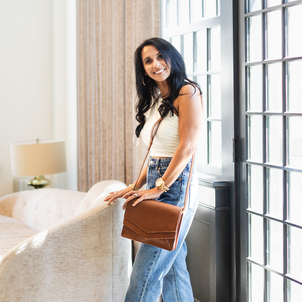 Woman wearing Elevate Crossbody and smiling