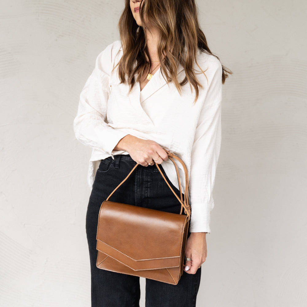 Woman holding Elevate Crossbody 